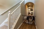 As you enter into the home there is a nook for jackets and shoes, then you can head upstairs to the bedrooms or hit the living room and kitchen. A gate to keep pets or kiddos contained 